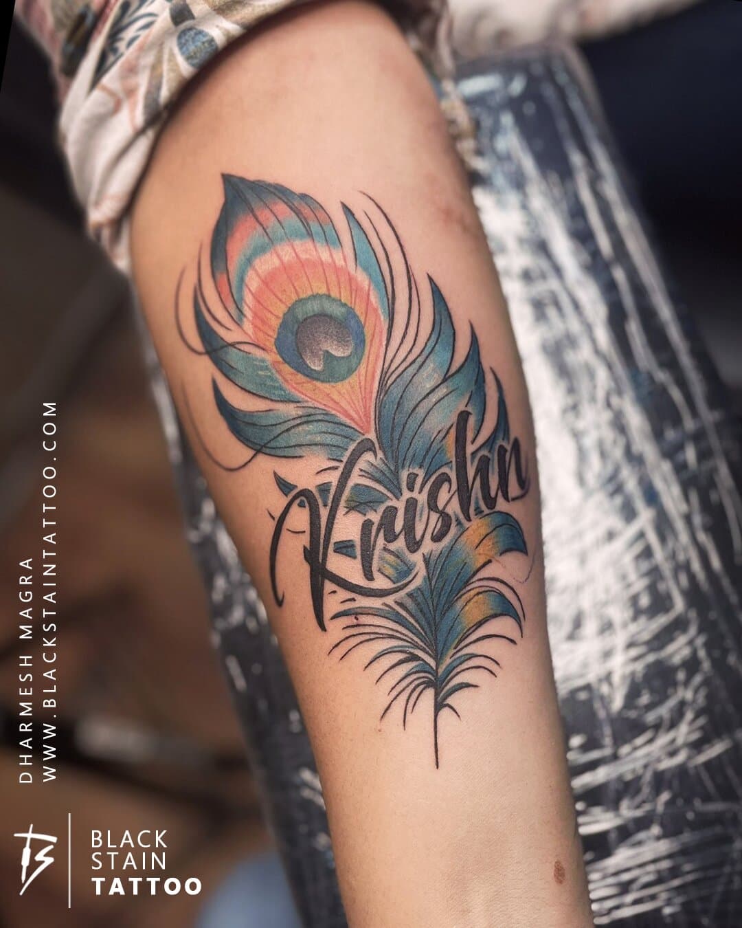 Colored peacock feather tattoo with vibrant hues - custom color design Ahmedabad