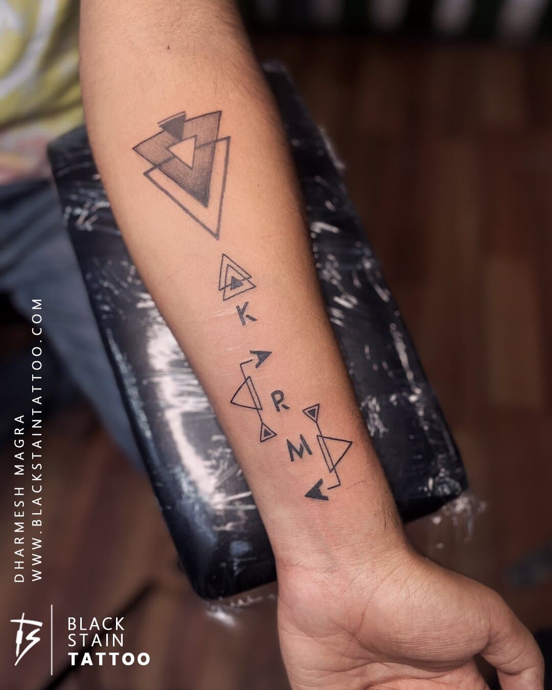 Geometric karma tattoo with stacked triangles - professional tattoo artist in Ahmedabad